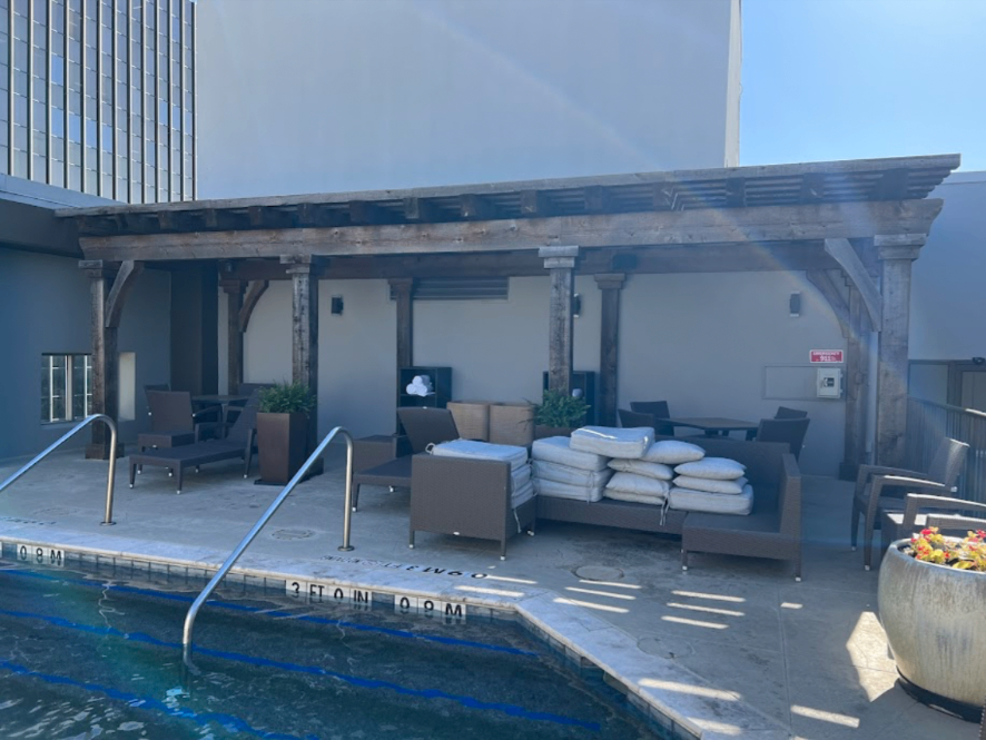 Rooftop pool deck with cedar pergola and lounge seating