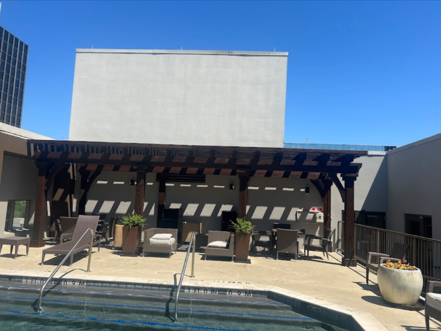 Commercial pool deck with custom timber pergola structure