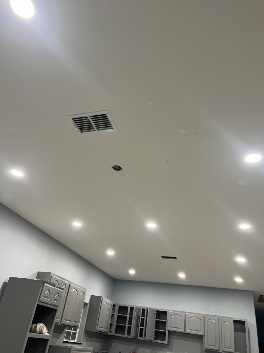 Smooth ceiling with recessed can lights and HVAC vent installation